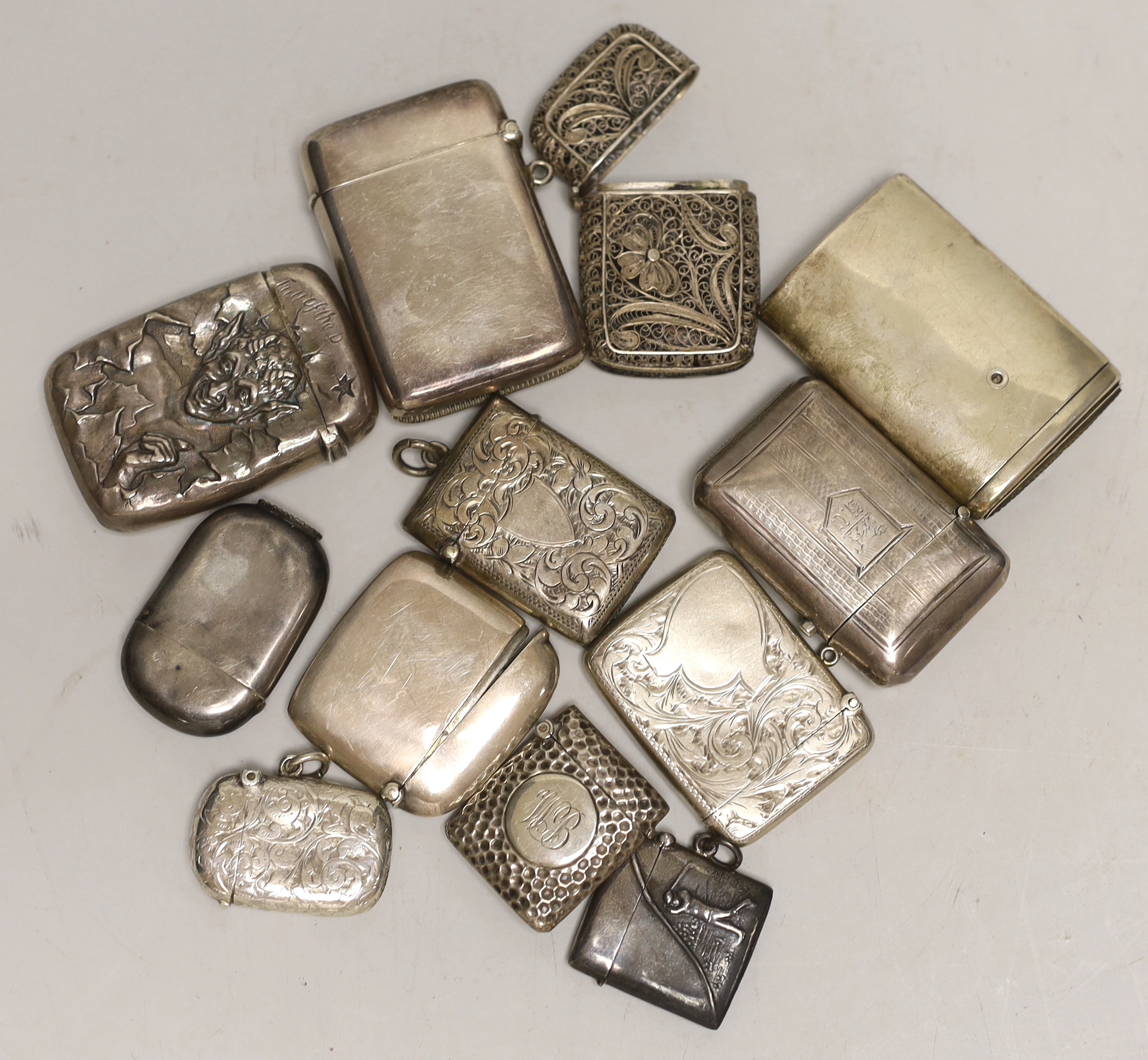 Nine assorted mainly early 20th century silver vesta cases, together with a filigree vesta case, a sterling vesta case embossed with a golfer and a 'Full of the D?' sterling vesta case, 61mm